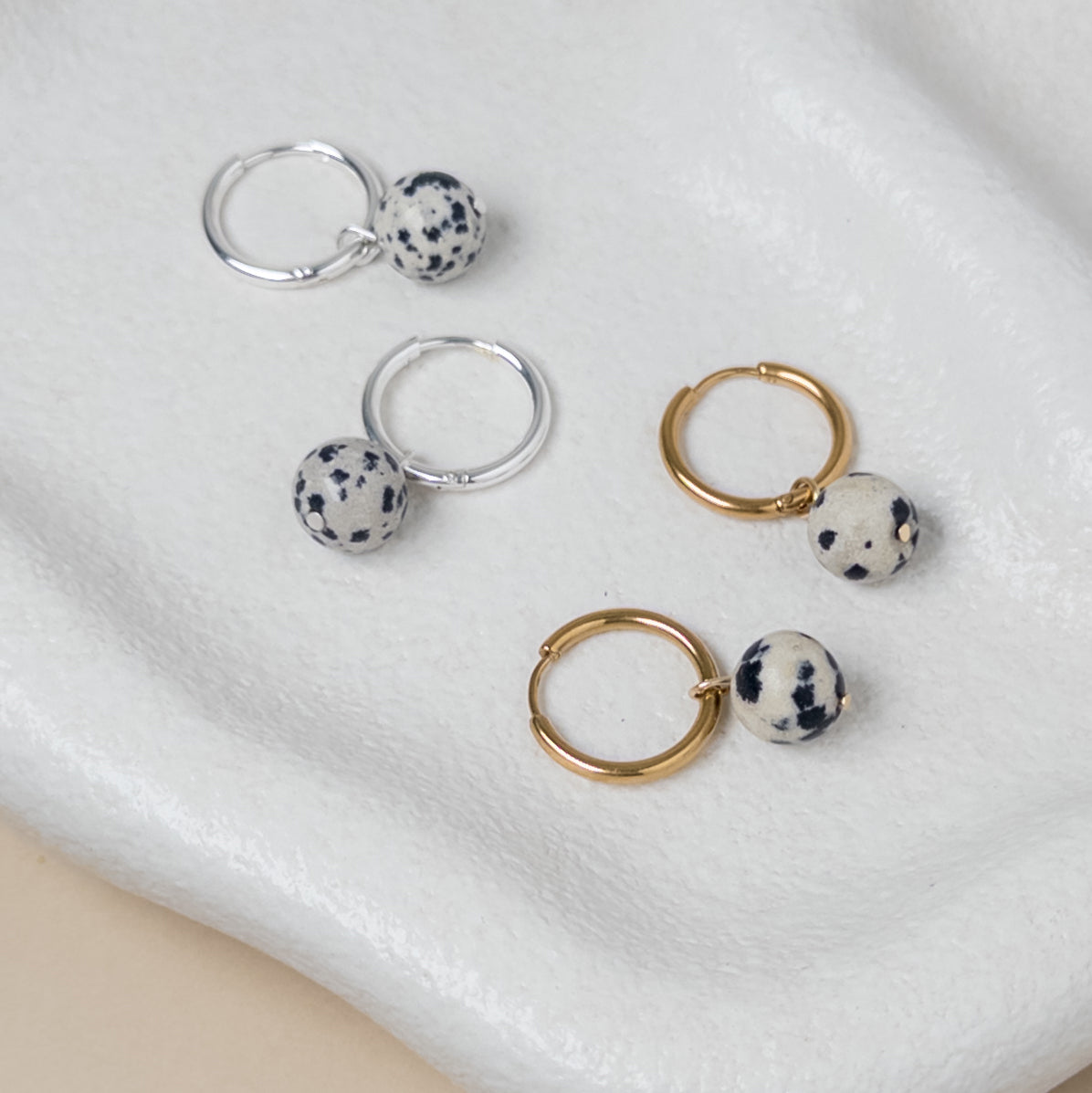 Silver and gold huggies with charms